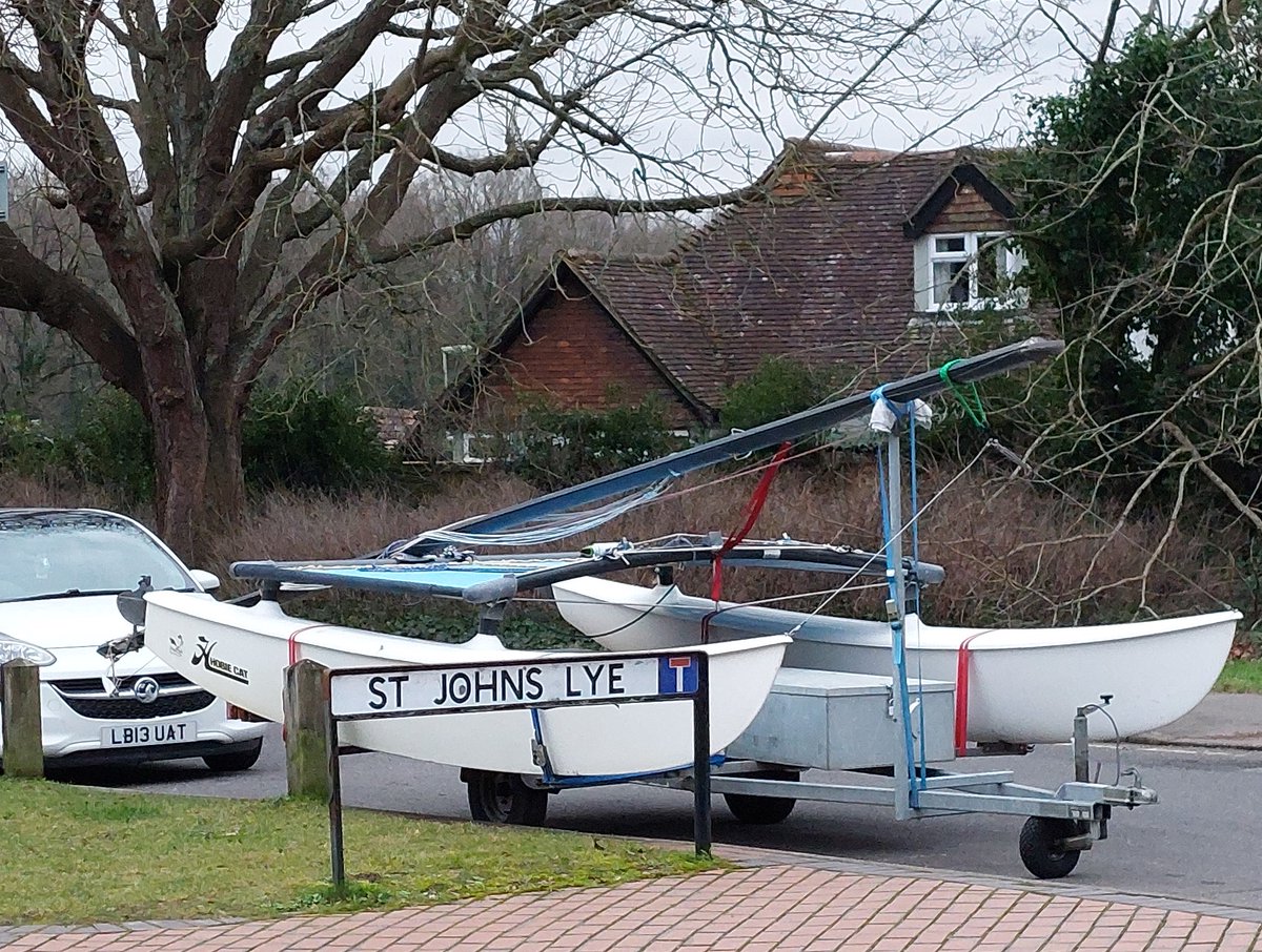 A catamaran - not what you expect to see parked next to the Basingstoke #Canal in St Johns, near #Woking. Good luck with your #sailing. 🙂