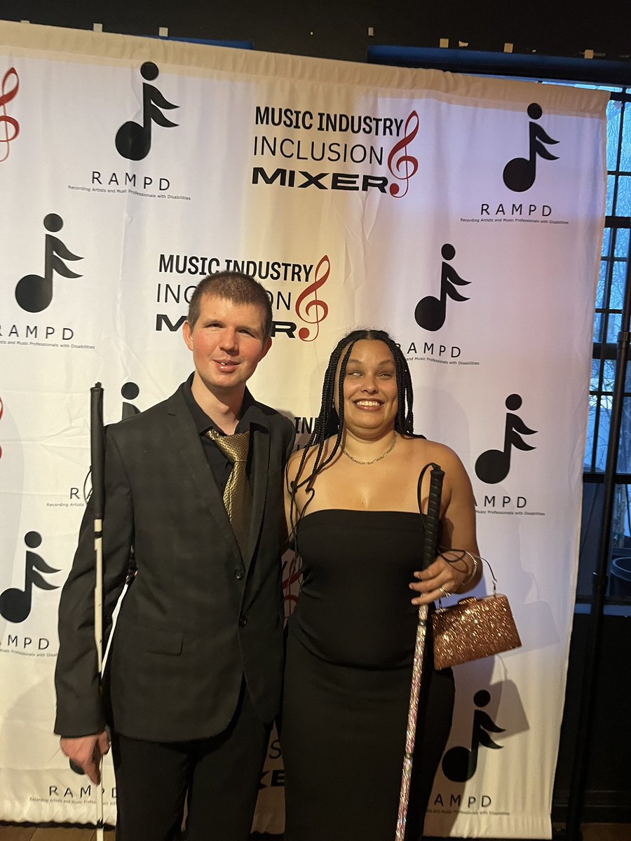 We had an amazing time representing @rampdup and celebrating disability  with so many friends at the Grammys week DEI party! #RAMPD #GlamCanes #DEI #Inclusion #GrammysWeek ID: Precious and Shane smiling in front of a backdrop with the text “RAMPD music industry inclusion mixer.”