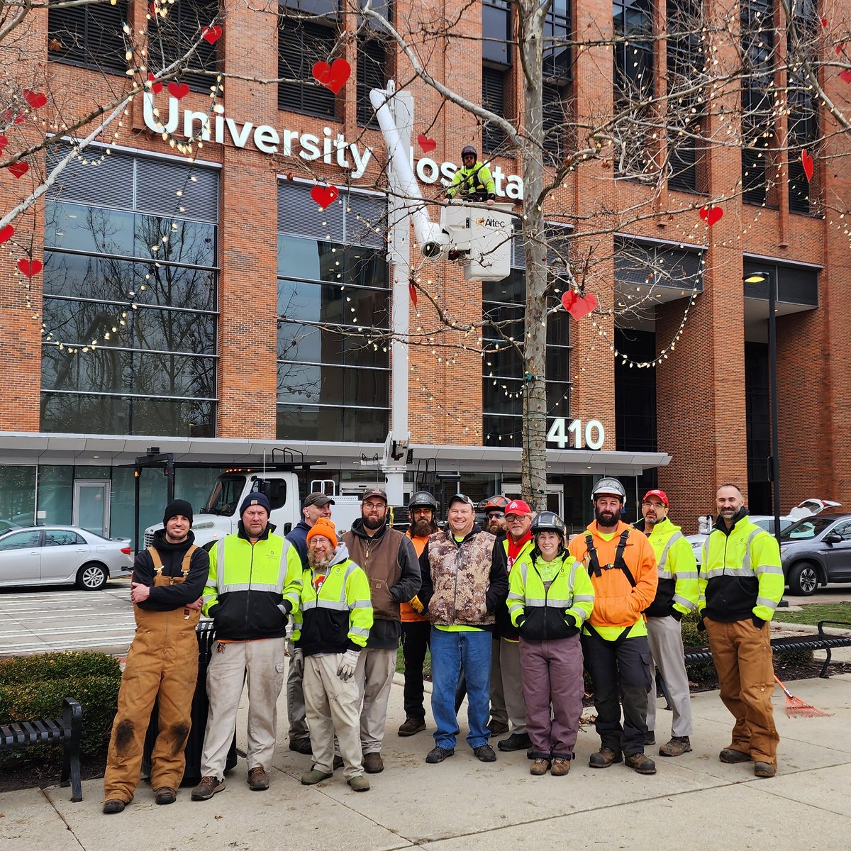 OhioStateFOD's tweet photo. Every year, our Landscape Services team hangs hearts in the trees in front of the Ross for Heart Month.  This year, we enlisted the help of our pruning crew so we could get the hearts higher in the trees. @osuwexmed #HeartMonth #BuckeyeLove https://t.co/b4J7TxiOHu