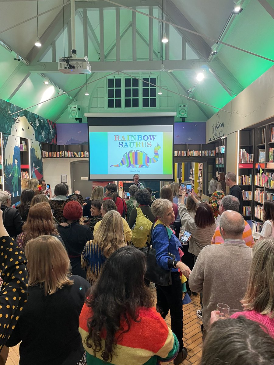 SwindonYFL's tweet photo. Librarians on tour! Fabulous evening celebrating @MrSteveAntony 10 years of magic and the launch of Rainbowsaurus. Lovely to bump into @jonesgarethp and  Nick Sharrat too oh and…AND Steve has dedicated the next @uksla magazine to us! https://t.co/PNa8cFbPYu