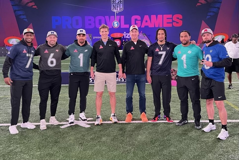 7 QB’s and one guy wearing jeans.