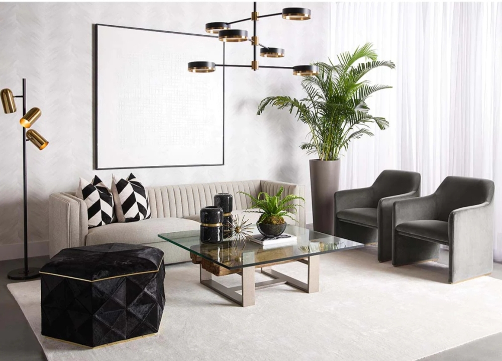 This large, glamorous ottoman offers elegance and allure. Features a geometric design with added storage. Stocked in black cowhide with a polished gold steel frame or grey cowhide with a polished silver frame. Also available in a small version.