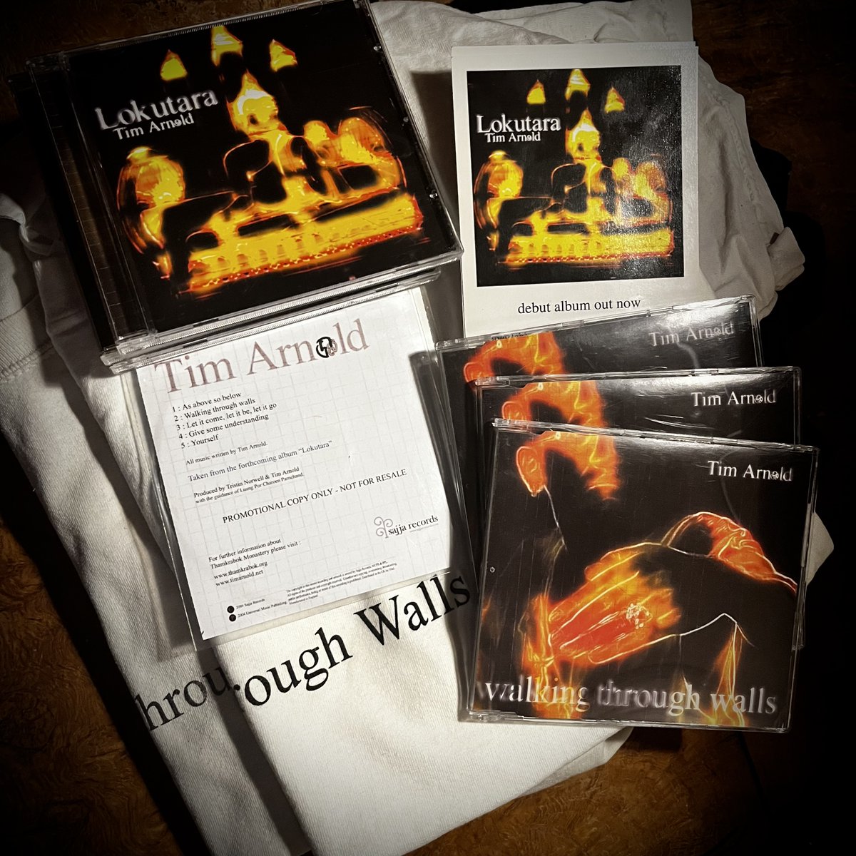 It's #BandcampFriday and we have merch! Out today for the first time in 20 years - The 20th Anniversary CD bundle of my debut album 'Lokutara', including the original 2004 CD album and single, vintage T-Shirt, Promo CD and Postcard. All signed. X timarnold.bandcamp.com/merch