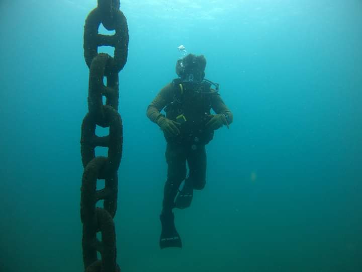 Hospital Corpsman 1st Class Nathaniel Yarbrough, assigned to Underwater Construction Team (UCT) 1, follows a buoy chain to surface during an underwater survey of a coast guard pier in Sao Tome, Sao Tome and Principe, Dec. 21, 2023. UCT-1 is on a scheduled deployment in the U.S.