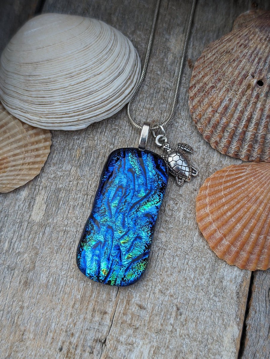 Wonderful new sea themed dichroic glass necklace. Lovely swirls of blues and greens in this handcrafted pendant. #handmade #giftideas #shopindie #valentinesdaygifts #jewellery #handcrafted buff.ly/3SF9u5m