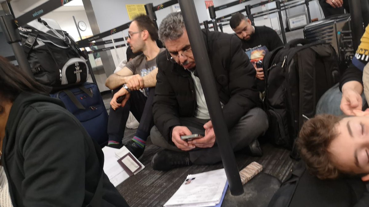 rishianand17's tweet photo. Situation at the immigration line at Toronto airport. People waiting for hours...made to sit on the floor #cringe
#immigrationnews 

@JustinTrudeau @MarcMillerVM @fordnation @CP24 @CBCToronto @TorontoPearson https://t.co/pjEpDh54Bl