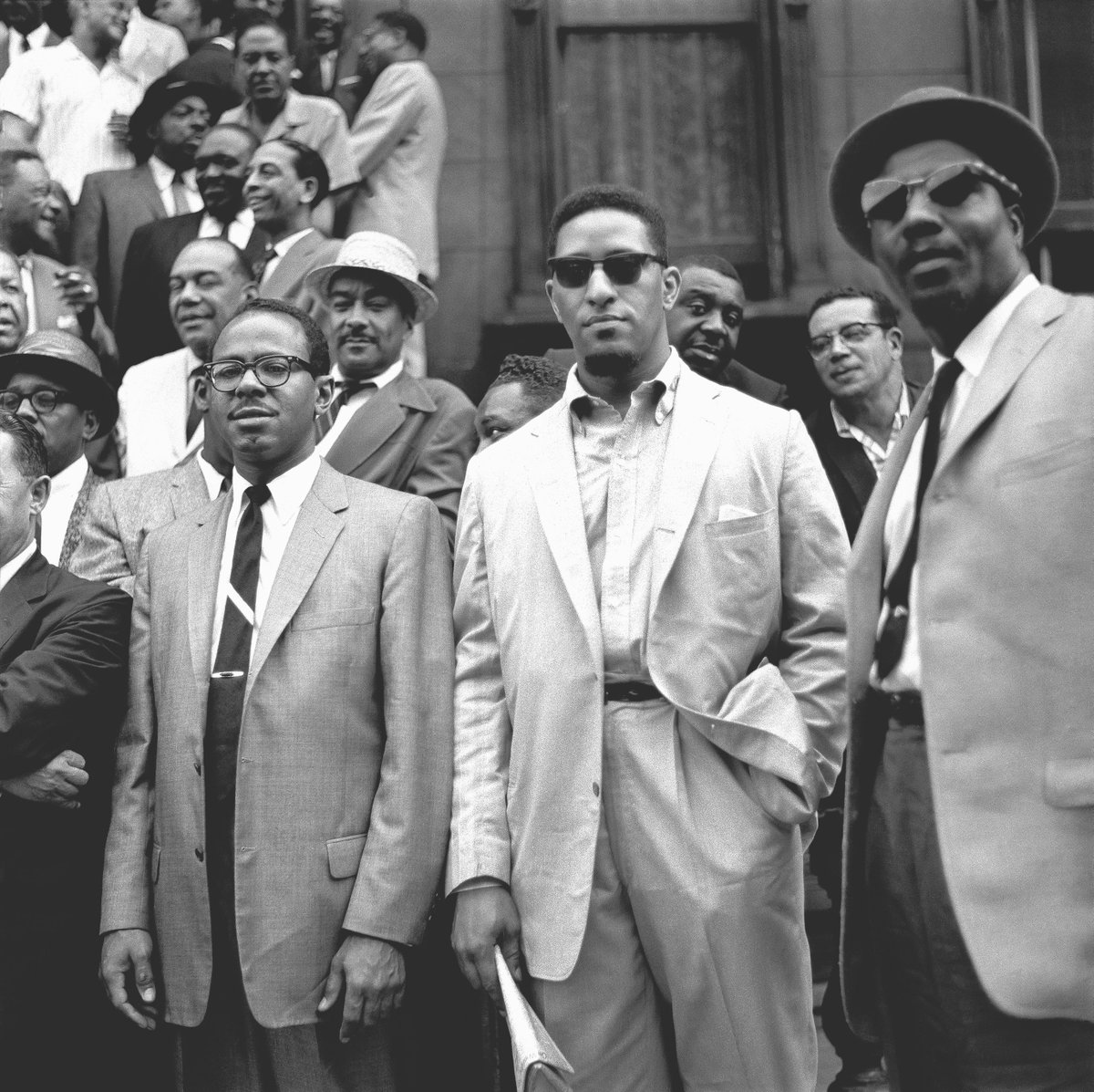 I encounter this attitude a lot here, and it demonstrates a great ignorance of one's own history. The suit certainly has something to do with white culture, but it's not wholly about white culture. 

Depending on how you want to trace the origins of the suit, you can date it back