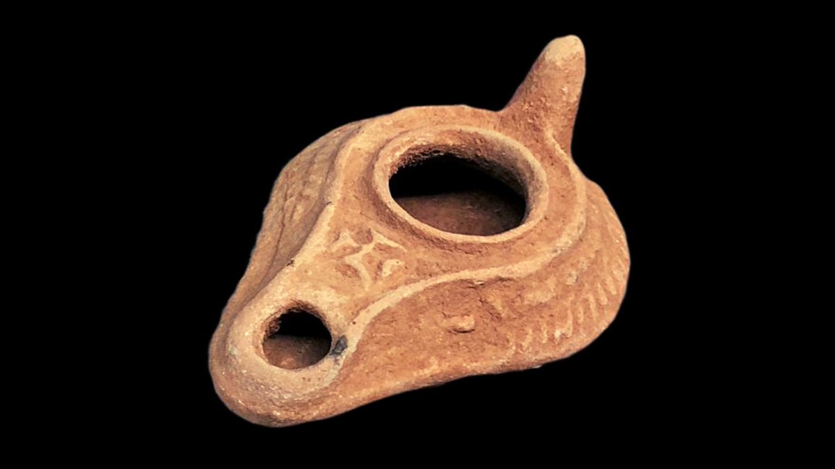 In the ancient world, lighting was very important. Before candles were devised, oil lamps and torches were used and the lamps often bore sacred symbols. This ceramic lamp is small enough to be hand-carried.(Coptic ~ 300 C.E.)