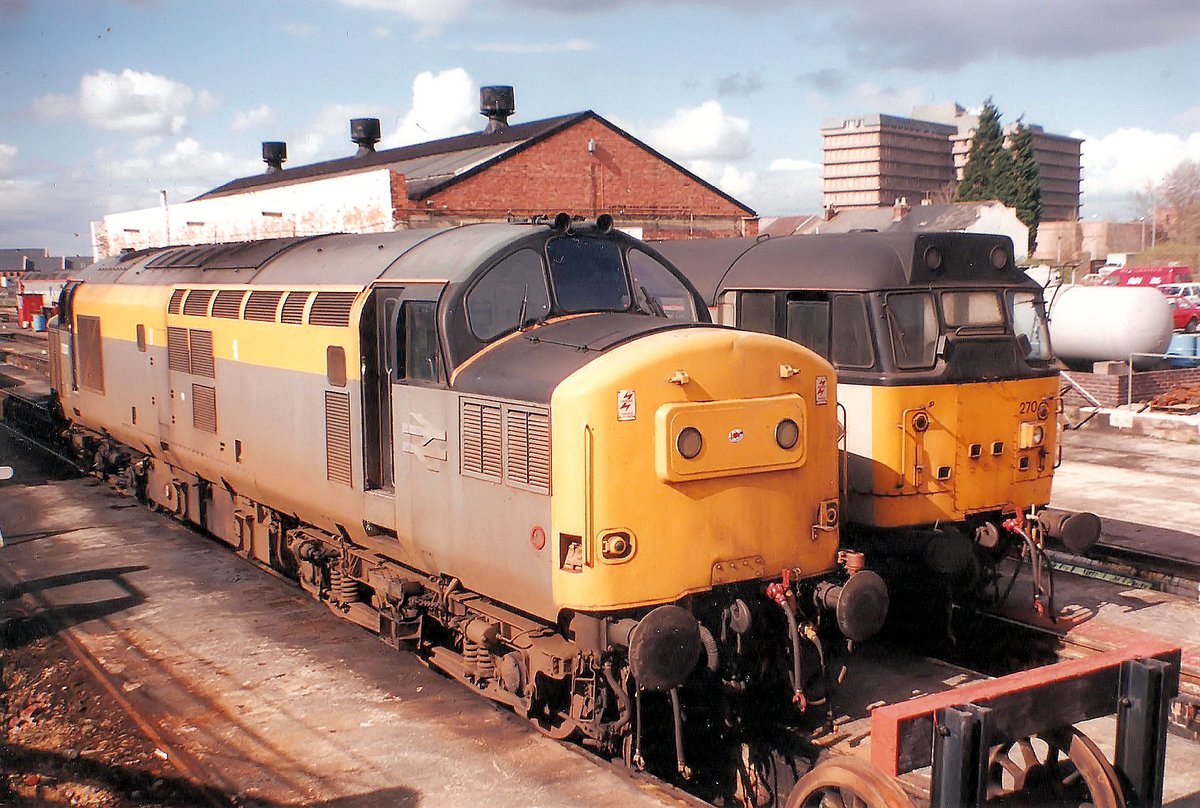 With the carbuncle of Gloucestershire Royal Hospital in the background, 37207 and 31270 are stabled at Horton Road, Gloucester on 21st March 1991.