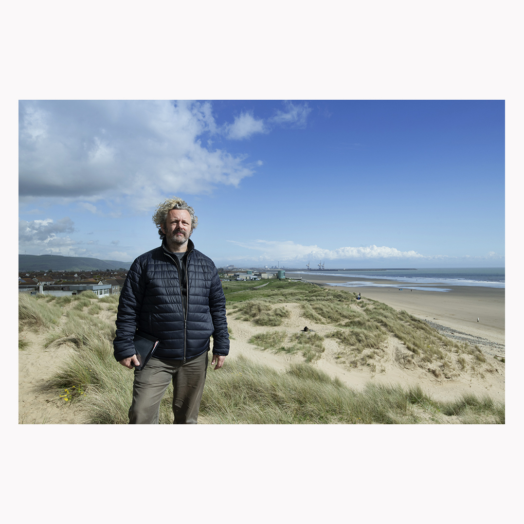 I've already seen this photo inexplicably cropped by two picture editors, so here it is in its unexpurgated glory! @michaelsheen working out some key scenes for #theway, cloaked in the sweeping vista of Aberafan and Port Talbot, with the iconic cranes behind