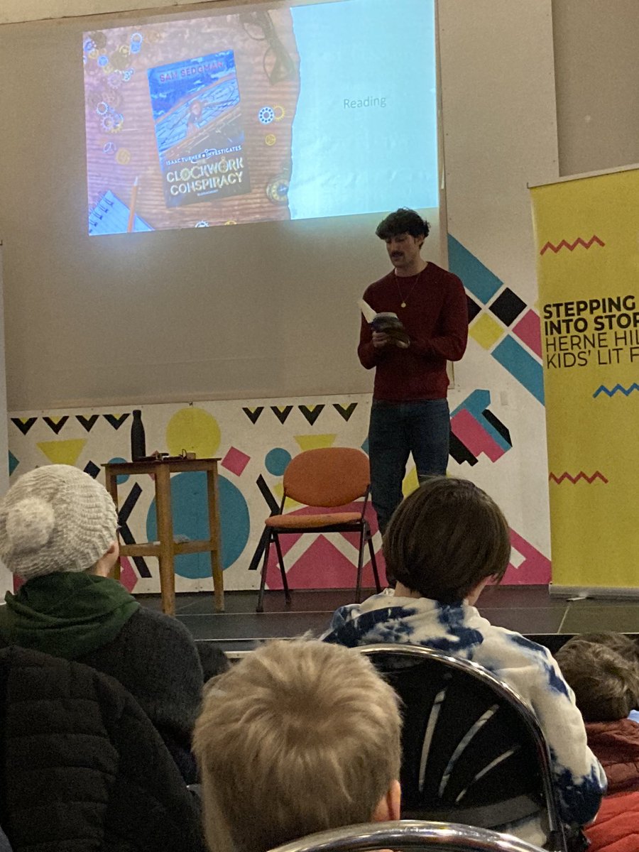 The wonderful @samuelsedgman reading the 1st chapter of The Clockwork Conspiracy at @stories_fest @paperdragon59 @Mo_OHara @KidsBloomsbury