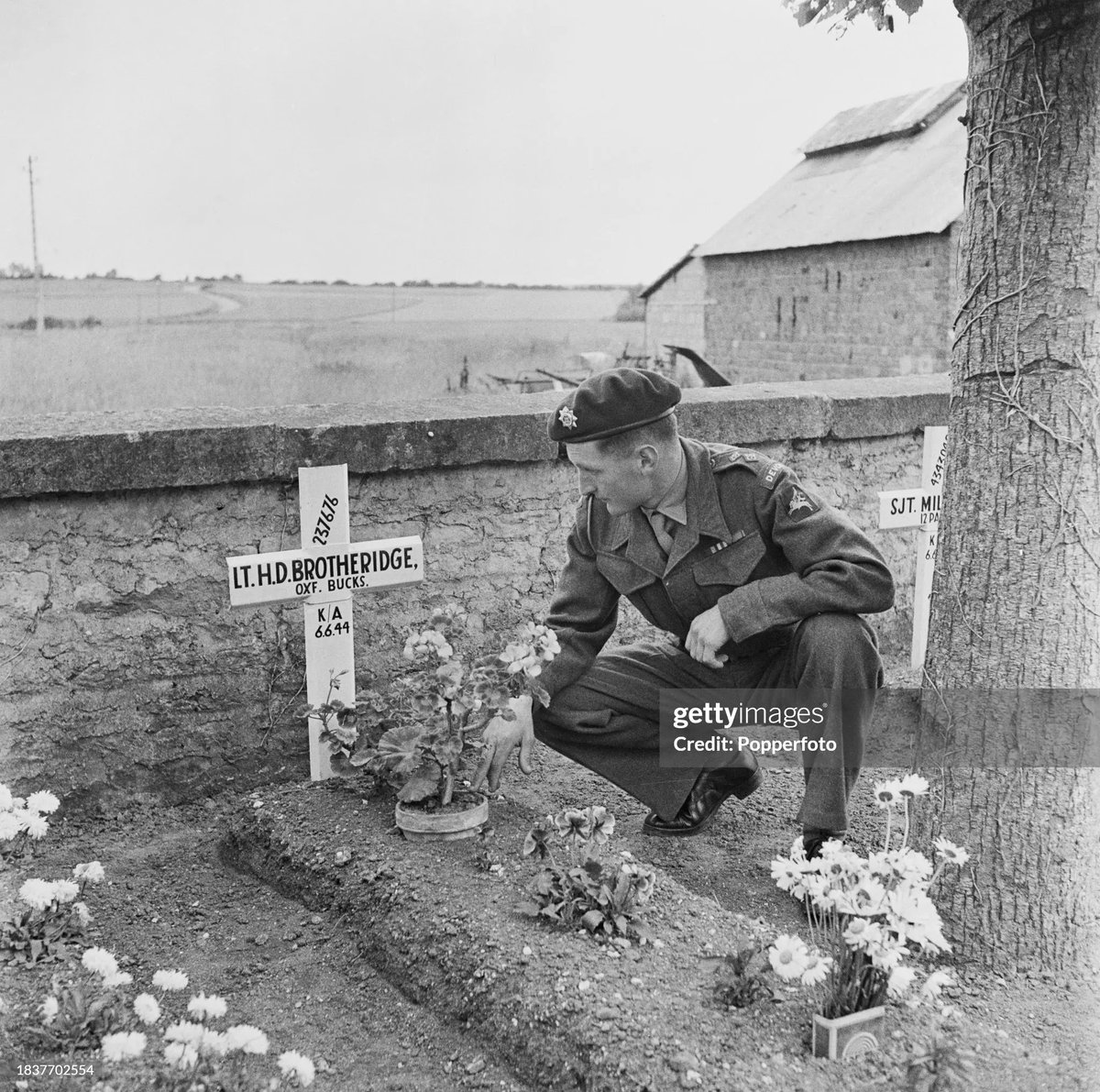 Lieutenant of the 12th Devons visits the grave of Lt. Den Brotheridge 2nd Bn Oxfordshire &amp; Buckinghamshire Light Infantry Ranville War Cemetery 29th June 1946. 
📸James Jarche