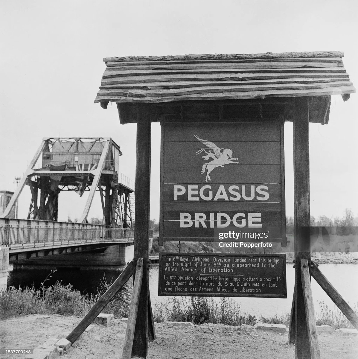 View of the Pegasus Bridge over the Caen Canal and commemorative sign during a first anniversary visit to World War II battlefields in  Normandy, France on 29th June 1946. 
📸James Jarche
