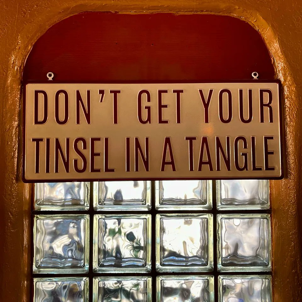 This image features a witty sign saying “DON’T GET YOUR TINSEL IN A TANGLE,” set against a #classic #glassblock window that evokes a sense of nostalgia. The sign’s vintage vibe aligns perfectly with the historic #RT66 and #HistoricRoute66 paying homage to  ;-)