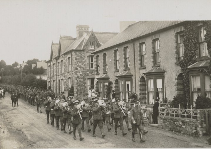 A band leads a parade of the 2nd/1st Pembroke Yeomanry Regiment down Rhosmaen Street during their stay at #Llandeilo, Carmarthenshire in 1915.