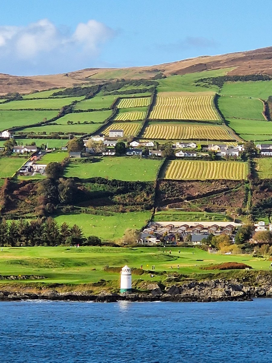 Sailing away from Greencastle ... loving the stunning shades of green in the landscape, definitely deserving of the name *Emerald Isle" #Ireland #irelandcruise #travelblog