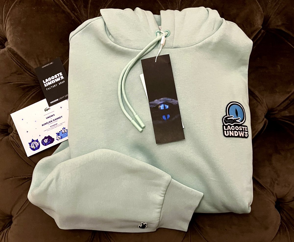 0xLoveNFTs's tweet image. I received my factory drop hoodie from Lacoste’s NFT project #undw3 💚 with some bonus stickers by Aurélien Jeanney. Great quality and I love the light green color. Most of my web3 hoodies are black, this will brighten up my wardrobe. #NFTCommunity