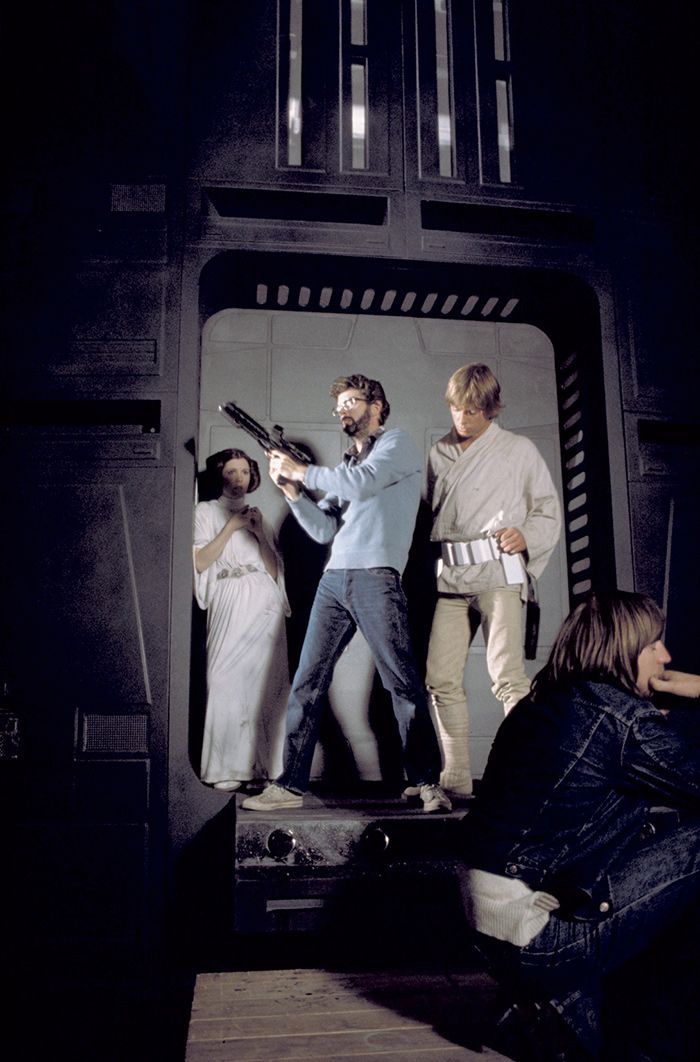 George Lucas showing Carrie Fisher and Mark Hamill how to use a blaster during filming of Star Wars (1977)