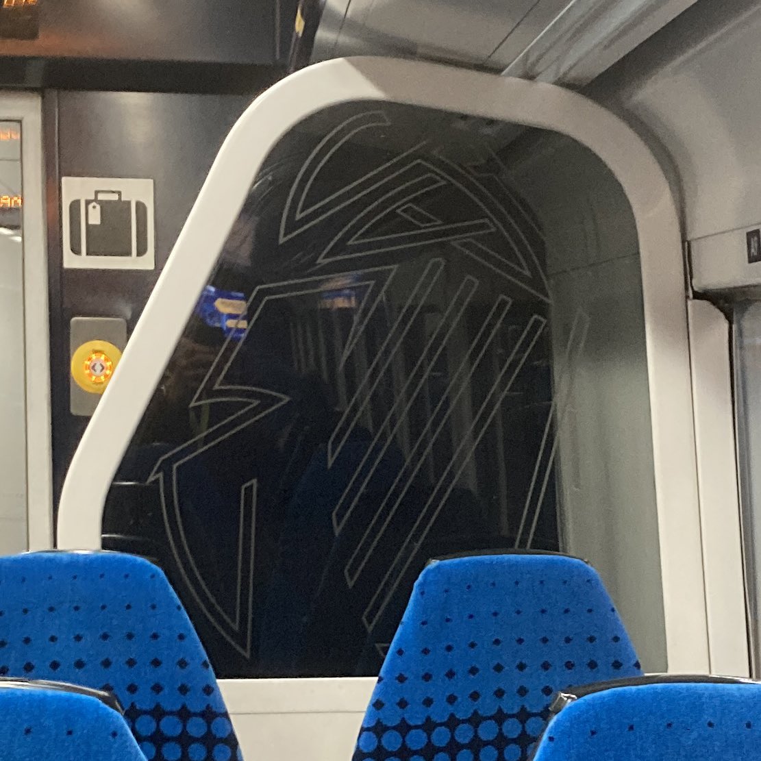 This glass decoration design still to be found in some Class 158s, was (if I remember correctly) to be found on them all when originally built for BR. But does anyone know if it had any meaning? Deconstructed double arrows? Or was it only ever purely abstract?