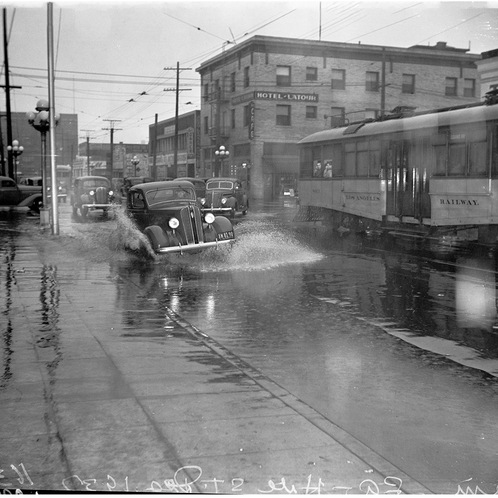 We've got this, L.A.! Stay safe (and dry) out there. 🌧️ #LARain . . . 📸: Automobile driving through flooding on Hill Street, December 1937. Courtesy the UCLA, Library Special Collections, Charles E. Young Research Library