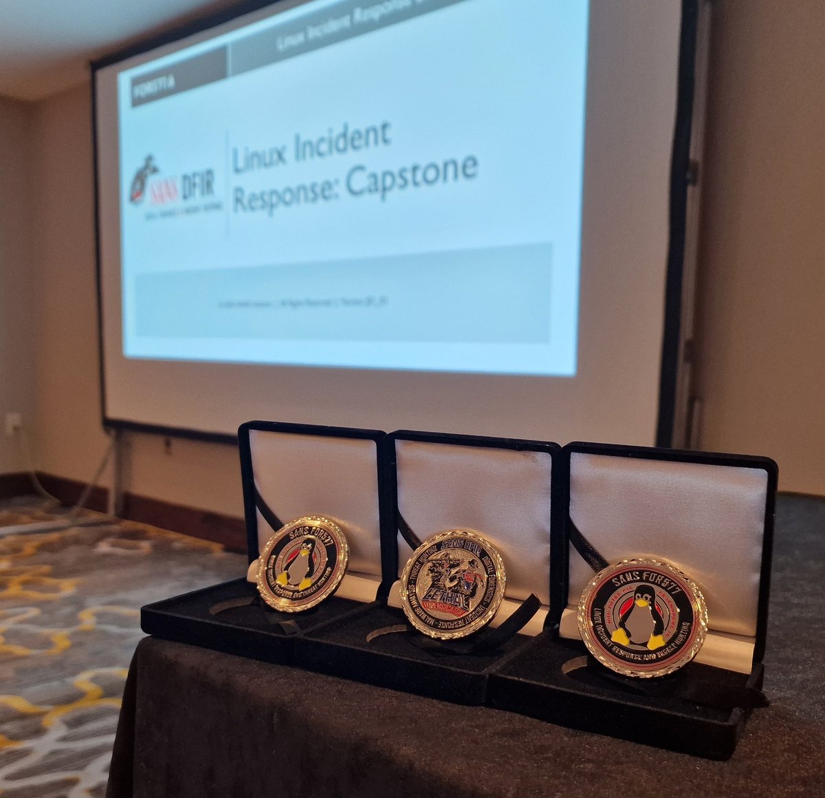 tazwake's tweet photo. In just three more hours, these awesome coins will be given out to highly skilled incident responders who have won the capstone challenge on #FOR577 - The Linux Incident Response course from @sansforensics. #Linux #dfir https://t.co/VzD734BZ2z