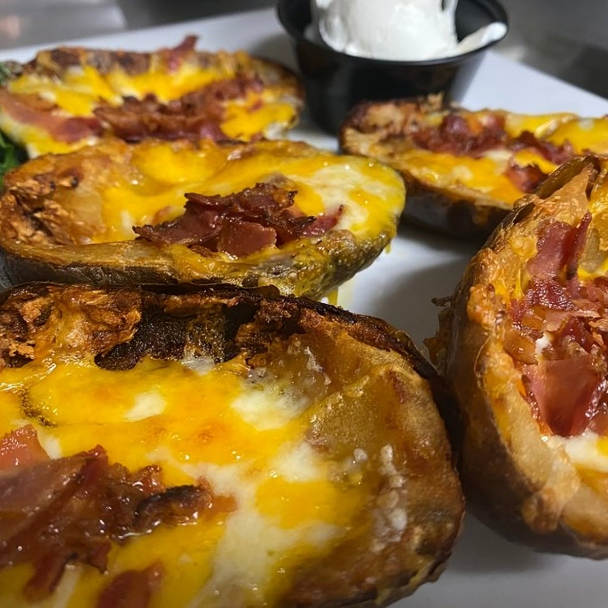 thefrenchpub's tweet photo. Start your meal off right with our Cheddar Potato Skins. 🥔 

They're loaded with flavor and make the perfect appetizer. Go on, indulge a little! 

Order for pickup here:
https://t.co/9Fpb2l3sdr https://t.co/zaMhDITBrW