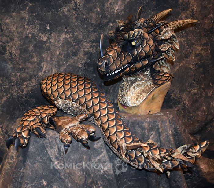 Dragon #100 features a beautiful scale fabric accented with handpainted gold edging. The gold fabric on the underside of the tail, throat and inner ears was hand smocked. Tongue, spikes and claws from @DvC_Ciara Horns from Red Nebula cosplay Eyebrow Ridges from @WeaselsOnEasels