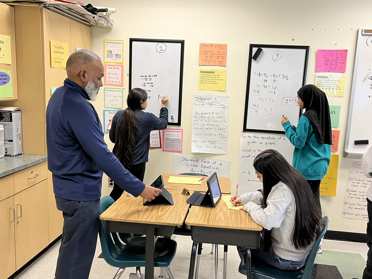 APSKenmore's tweet image. Ms. Parkhurst’s Pre-Algebra students are working in small groups solving equations with variables on both sides with Mr. Dia. #VerticalInstruction #MathDiscourse @APSMath @mgoodman06 @APSVirginia