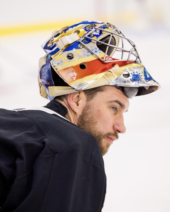 Anthony Stolarz on the ice at the Baptist Health IcePlex for morning skate. He’s leaning over, with his mask resting on his head so you can see his face. He’s wearing a black practice jersey.