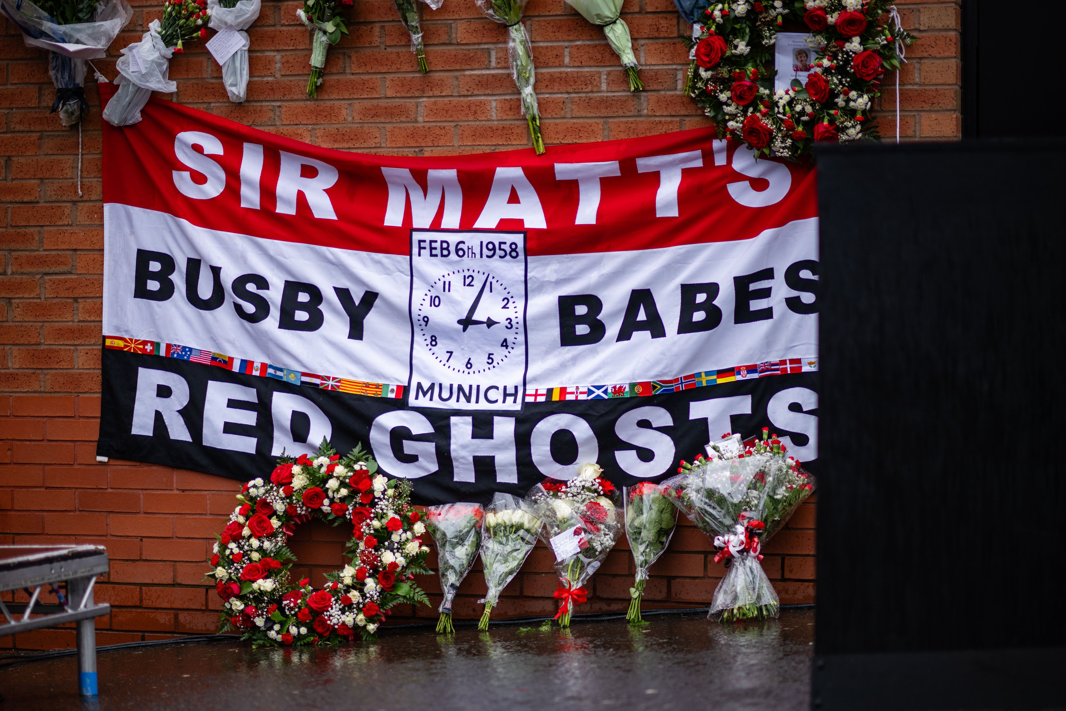 A flag reading 'Sir Matt's Busby Babes Red Ghosts' at today's Munich memorial.