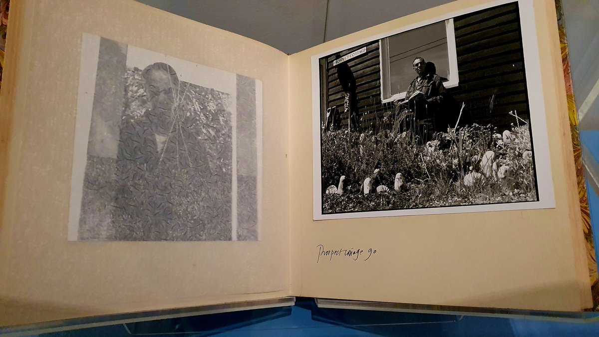 BooksnMagic's tweet photo. Derek Jarman's photobooks from the early 90s on display at the William Morris Museum in the "Radical Landscape" exhibition, placed beneath a screen playing Jarman's movie, The Garden. https://t.co/jR5yCn4wDx