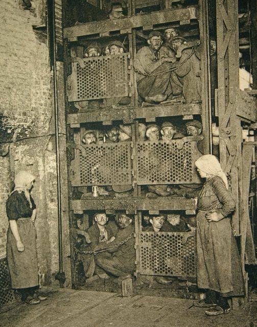 1930,miners in lift.