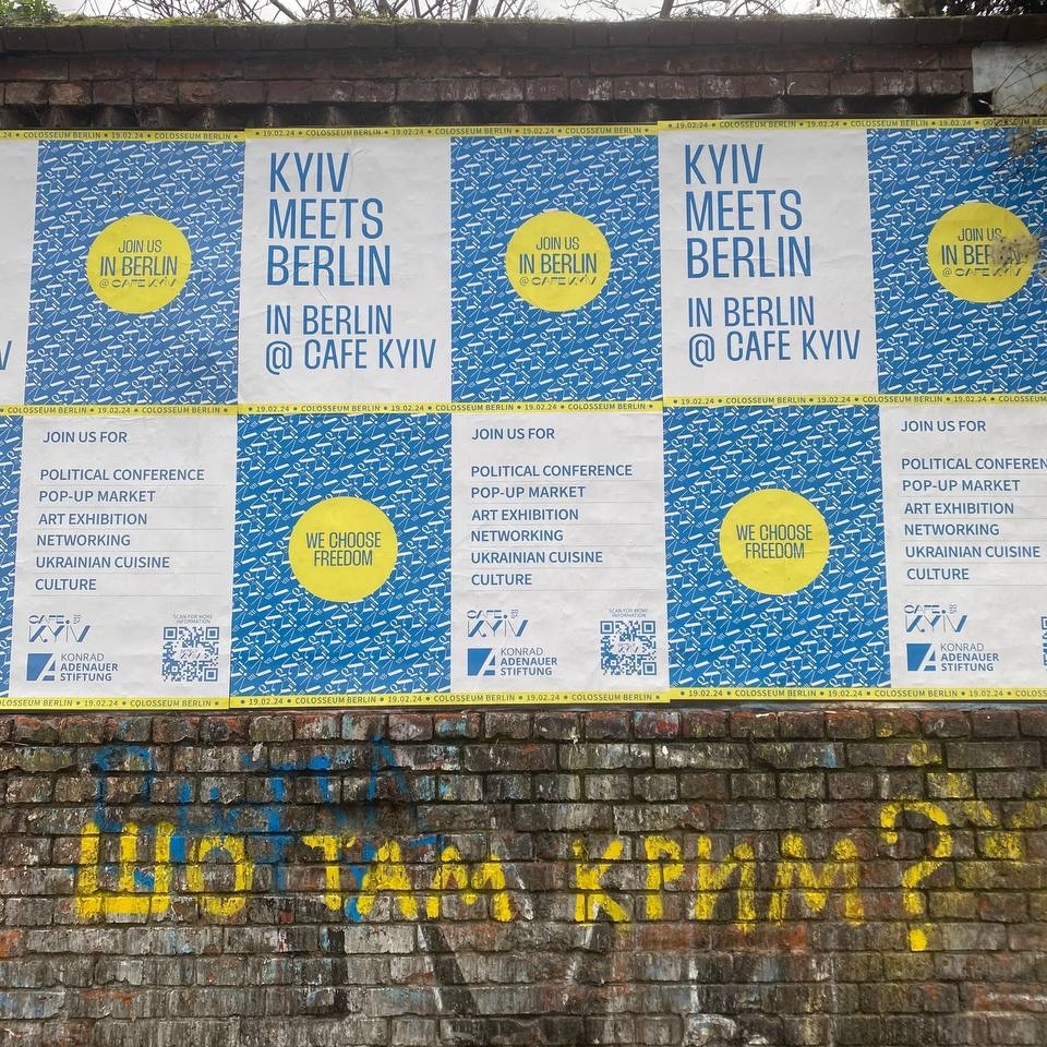 'What's about Crimea?' is written on this wall in Berlin's Friedrichshain. '#Crimea is #Ukraine' – that is our response to it. It's very symbolic that our Cafe Kyiv posters were placed exactly on this wall. Come to #CafeKyiv on 19.02.2024 & learn more: cafekyiv.kas.de/en/