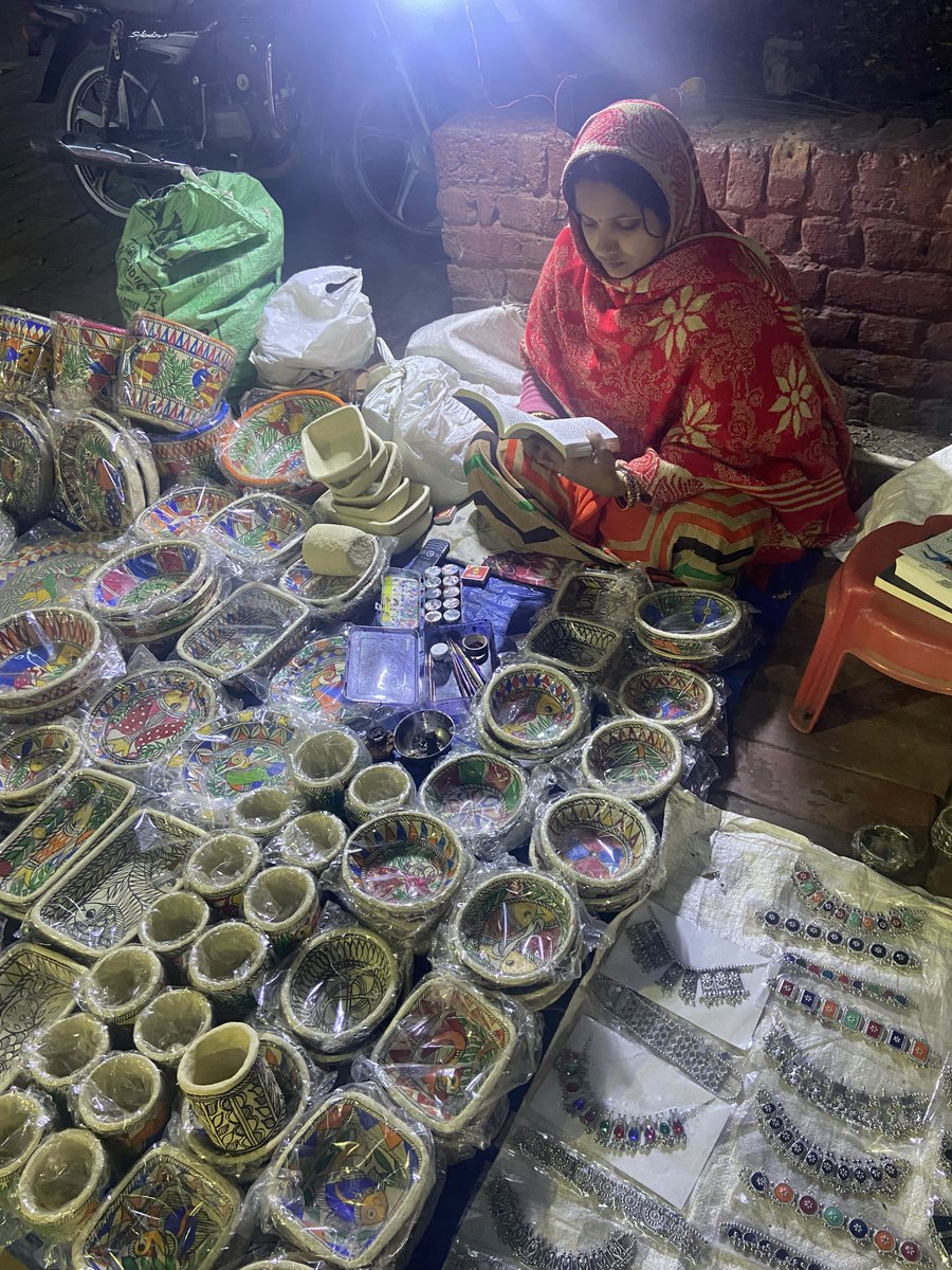 Nisha has finished class 12. Makes these papier-mâché bowls and pen holders out of waste paper..Her husband is a Madhubani painter. They migrated from Darbhanga, Bihar. I noticed her because she was reading a book. Next to her was another book - Sophie’s World.