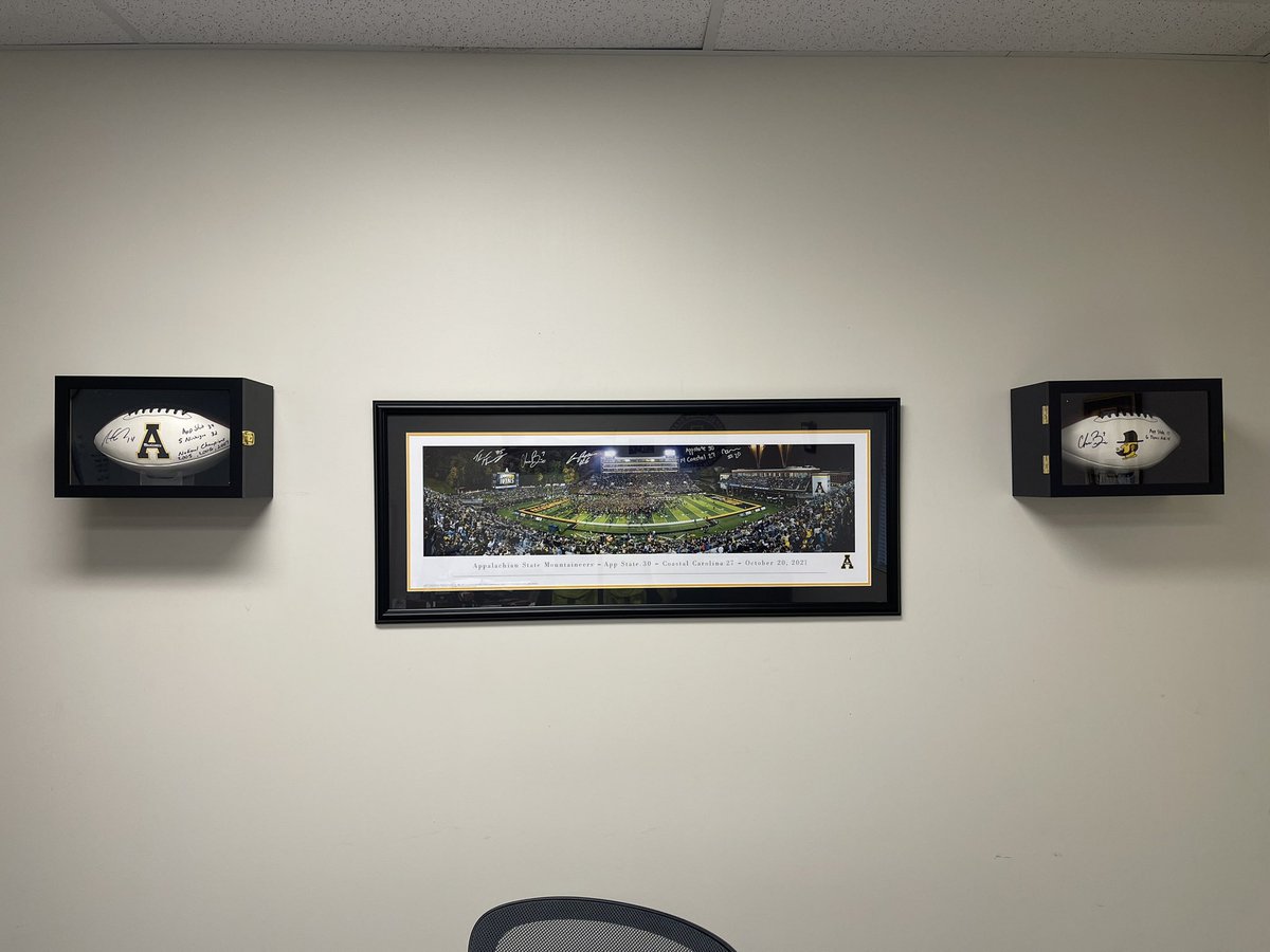 The office is set up. @armanti_edwards autographed football referencing MI upset. @chasebrice7 autographed football referencing A&M upset @Cam_Peoples6 @_t_Henni @chasebrice7 @NNoel_2 autographed picture from Coastal Carolina upset #Appstate 🟡⚫️