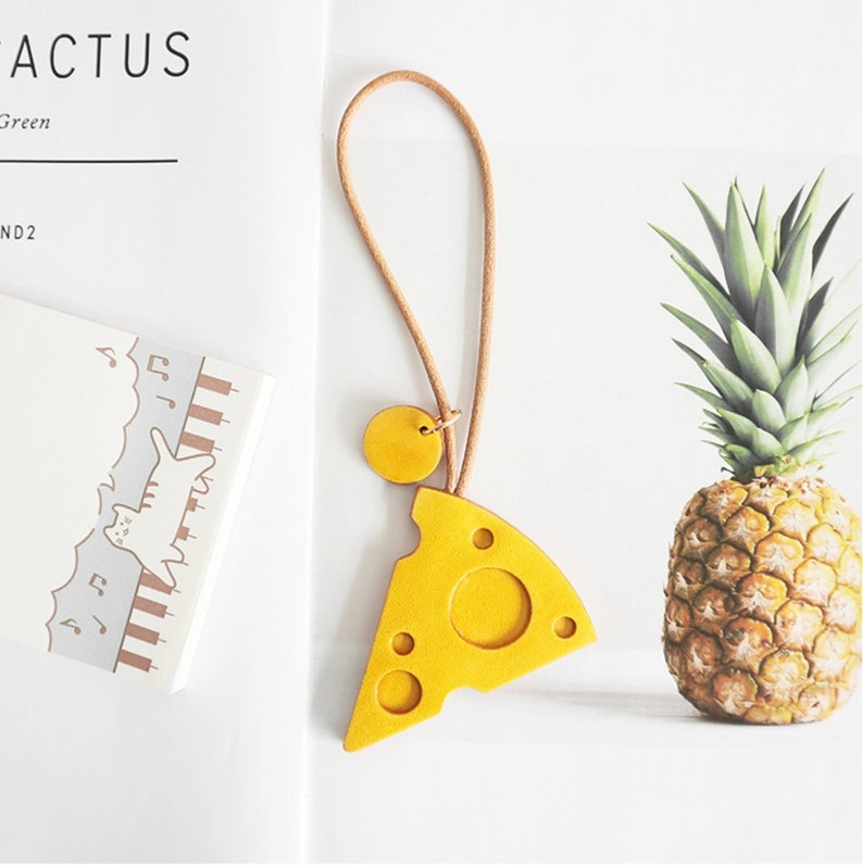 SelectizaCo's tweet photo. Add a touch of whimsy to your keys with our handmade leather cheese keychains – a charming accessory! https://t.co/7EBGl8UdAC
