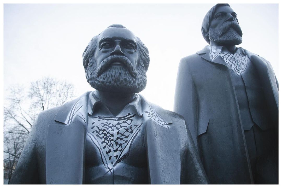 Looks like the old East German-era Marx and Engels statues in Berlin got tagged with Palestinian keffiyeh graffiti today.