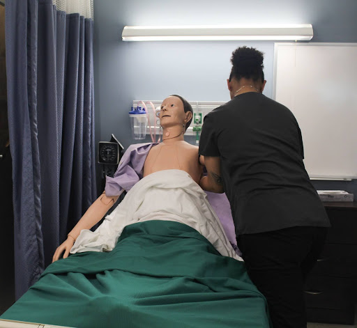 In Addition to taking blood pressure, students practiced clothing patients with a paralyzed arm. In order to cloth the patient, students began with the affected arm. When it comes time to remove the clothing, it is vital that you start with the unaffected arm first.