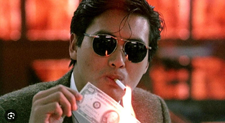 MaxBarnes654528's tweet photo. A shot from the beginning of the classic John Woo film, A Better Tomorrow. It is a closeup shot that ignores the rule of thirds and instead places the character in the center of the frame with a shallow depth of field, forcing the complete focus of the audience to him. #smc355 https://t.co/oYdrNGsce4