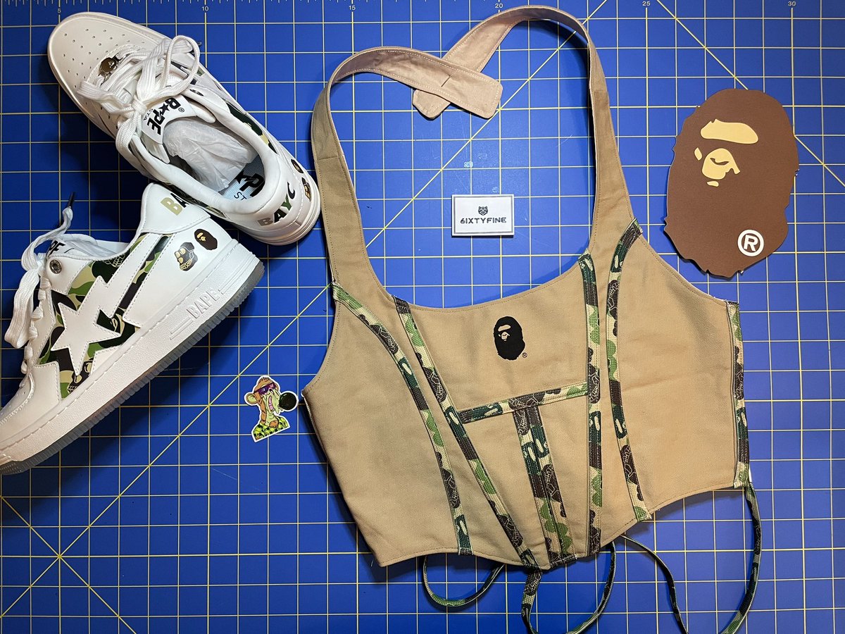 If <a href="/BAPEOFFICIAL/">BAPE.COM</a> + <a href="/BoredApeYC/">Bored Ape Yacht Club 🍌</a> + @6ixtyfine had a baby 

Repurposed shoe dust cover bag and shoelaces into a one of a kind corset top - fully lined, boning throughout, lace up back. 

side note: do you like the work in progress videos? should i post? 

after: