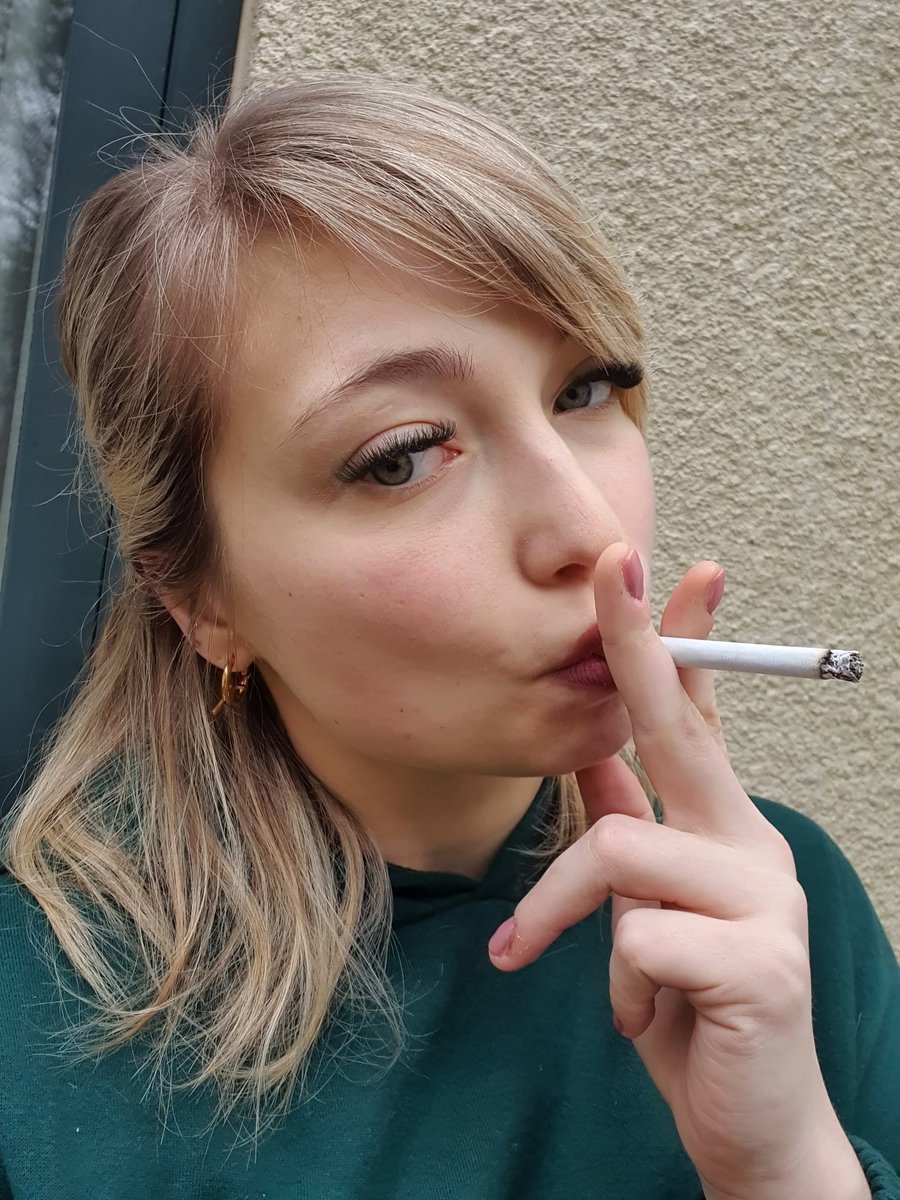 A moment of relaxation and self-care - here, I'm enjoying a flavorful cigarette, letting the day unwind. Sometimes, it's the simple pleasures that bring us the greatest joy. How do you spend your moments of relaxation? #smokingwomen #smokingfetish #smokelove #cigarette #beauty