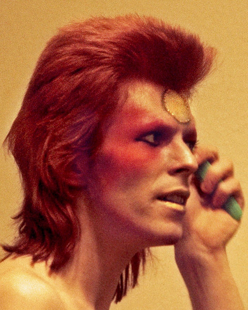 DavidBowieReal's tweet photo. V&A BOWIE ADVERT IN MOJO

“Yeah! I ran to the street looking for information...”

The first picture here is one of Mick Rock’s backstage photos of Bowie in Scotland in May 1973, possibly the Music Hall in Aberdeen on the 16th...somebody will know.

The second image is the full-page V&A advert running in the current edition of MOJO magazine (April). The ad was published to build excitement for the Bowie Archive which will open at V&A East Storehouse in 2025.

It’s of an anabas poster issued in 1974 with a photograph taken possibly at the same 1973 Aberdeen show. If memory serves, this shot, along with others, was taken for a local newspaper report.

The anabas company cornered the market with this type of thing, licensing an image which would be repeated across several pieces of merchandise, including a badge, pendant, keyring and poster. See the third image for the pendant utilising the same shot.

The final image is the full-length version of the first shot because it would be rude not to include it.

📸 Mick Rock

#BowieArchiveVAM  #BowieScotland