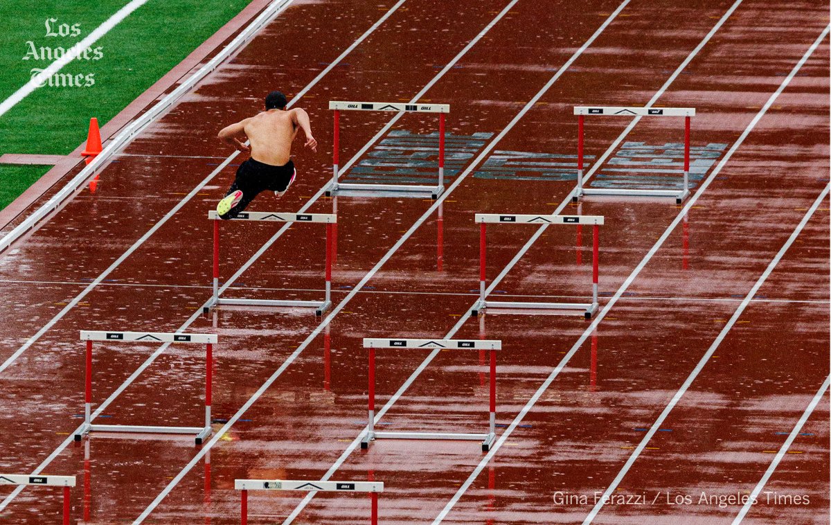 A constant rain storm doesn't keep the Riverside City College track team from practicing the hurdles on a wet track as more torrential rains hit Southern California #rain @latimes