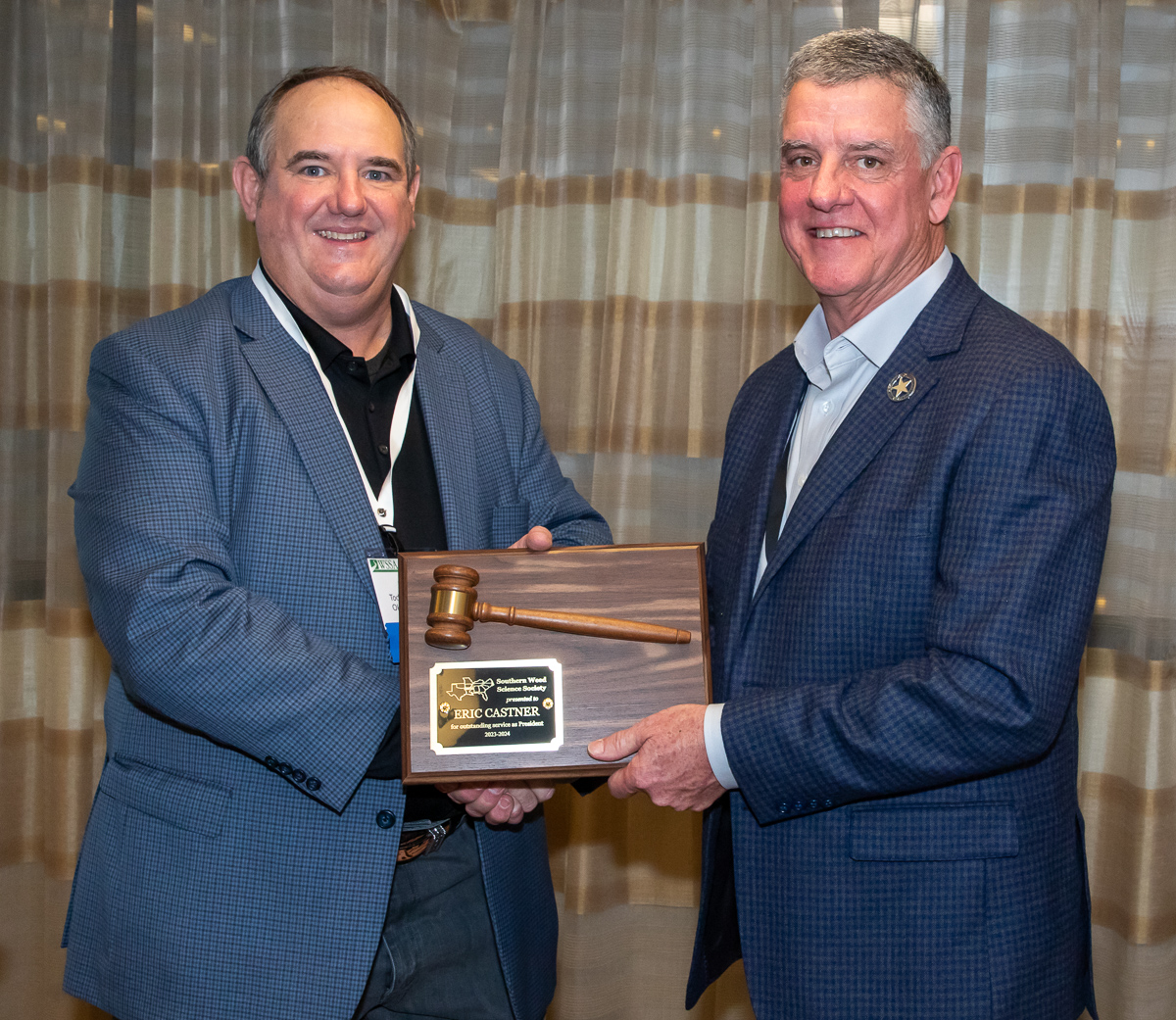 Dr. Eric Castner at #SWSS2024 received a commemorative gavel for his service to SWSS for the past year acting as president, and we welcome the new president, Dr. Todd Baughman (@oSu_WeedScience), with the passing of the gavel!