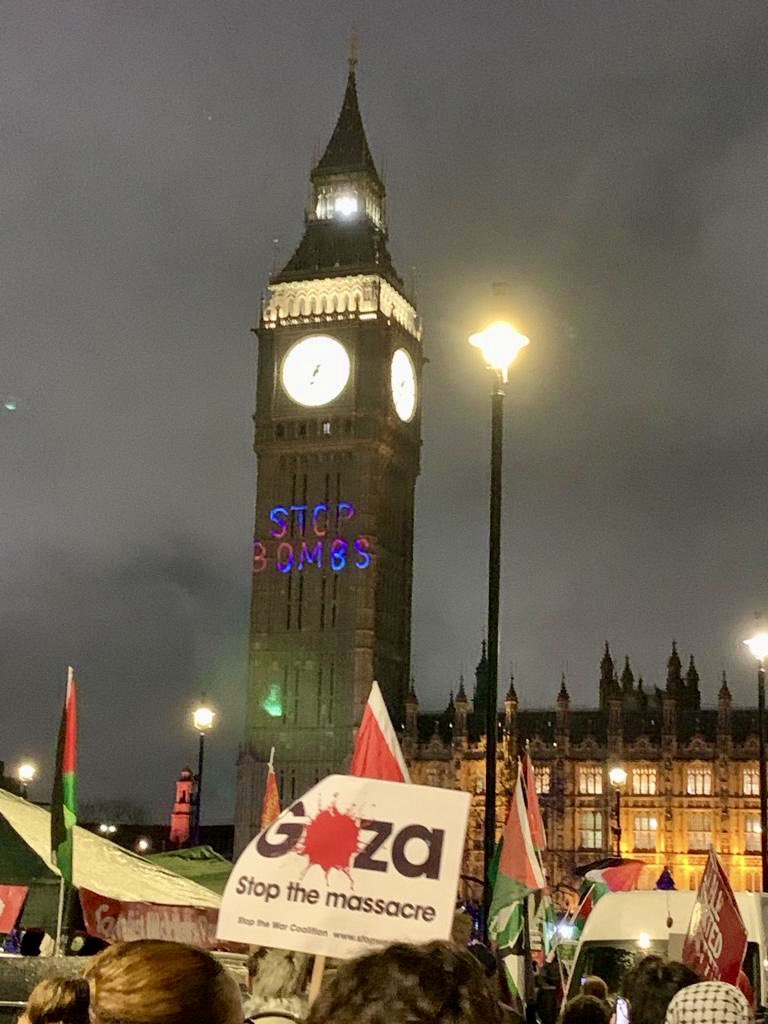 Parliament this evening. Projected on to Big Ben are the words STOP THE BOMBS. #StopTheGenocide #CEASEFIRE_NOW photo credit <a href="/MillionWomen/">Million Women Rise</a>