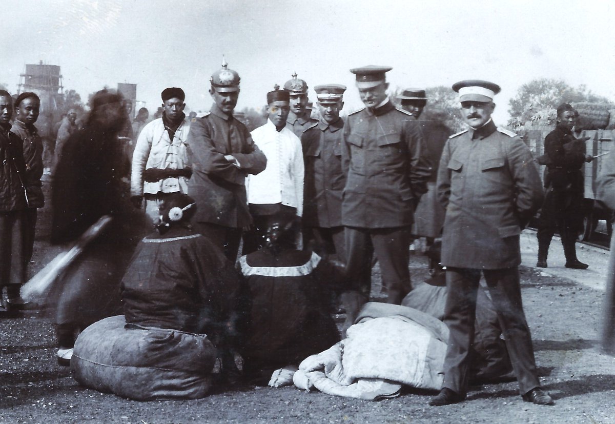 German troops stationed in #China #中国, posing at #Tianjin #天津 (#Tientsin) train station with locals, c. 1907, from a German military album.