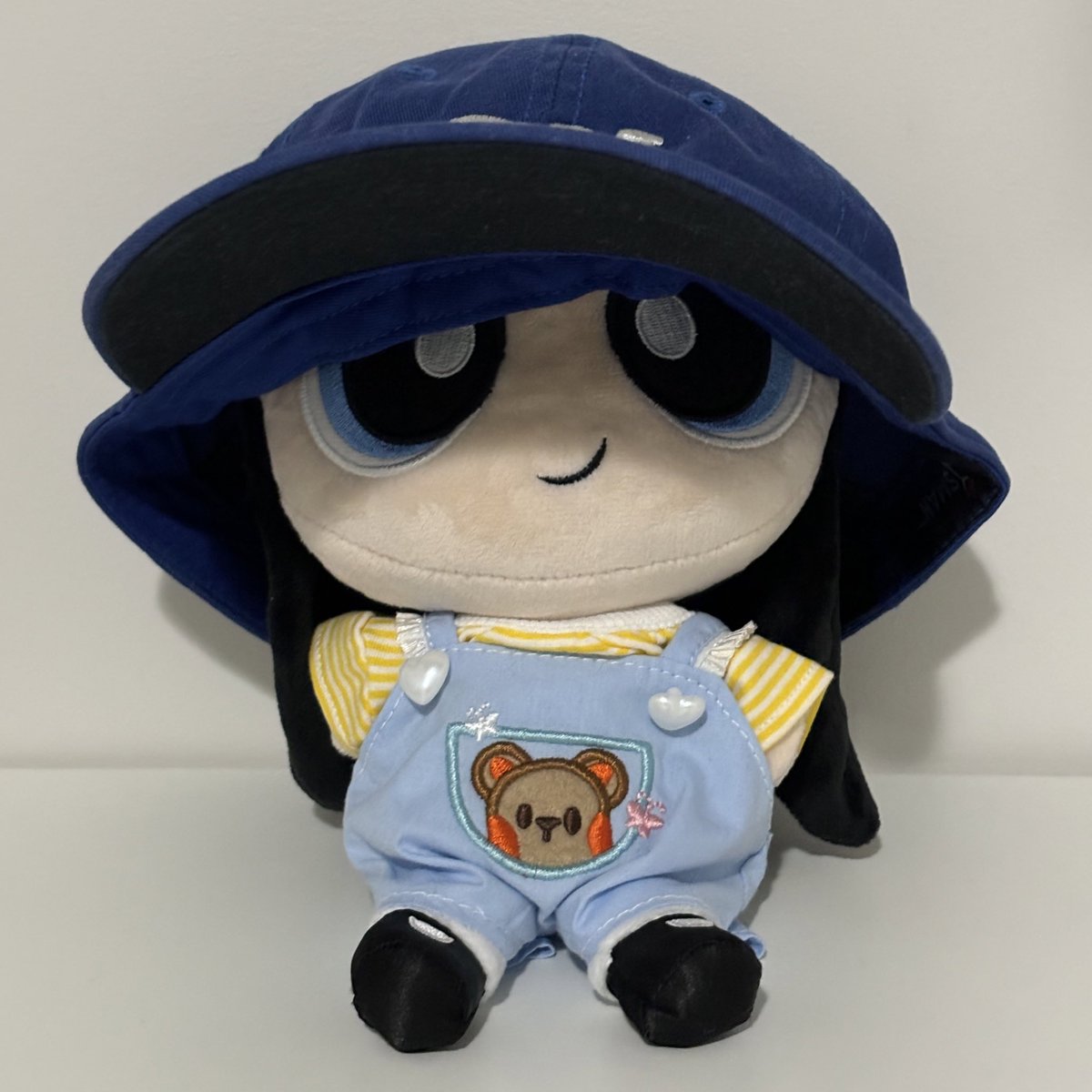 cozy in her bear overalls and cap 🧢🫶🏻