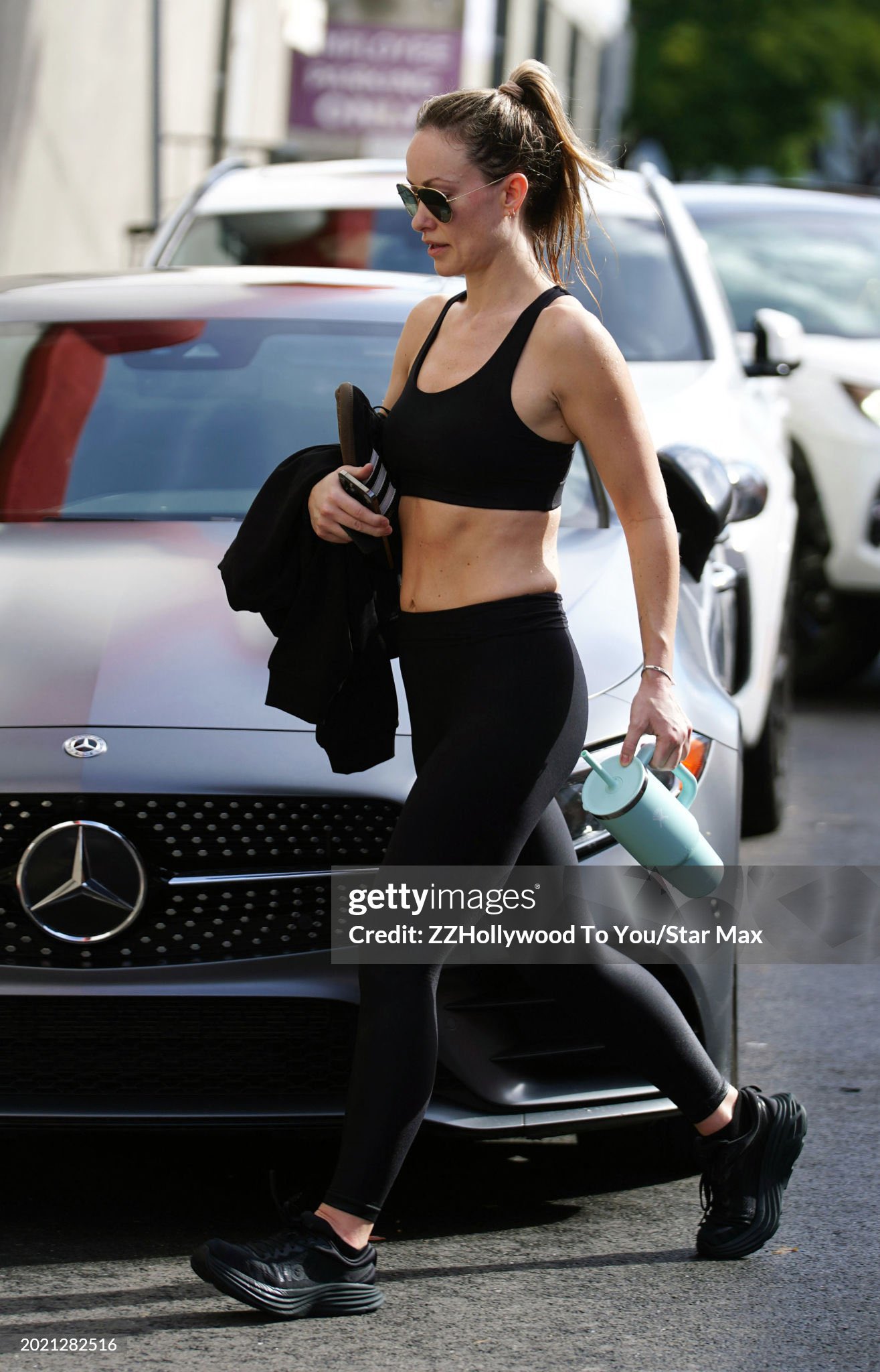 Olivia Wilde sports a black crop top and leggings as she leaves