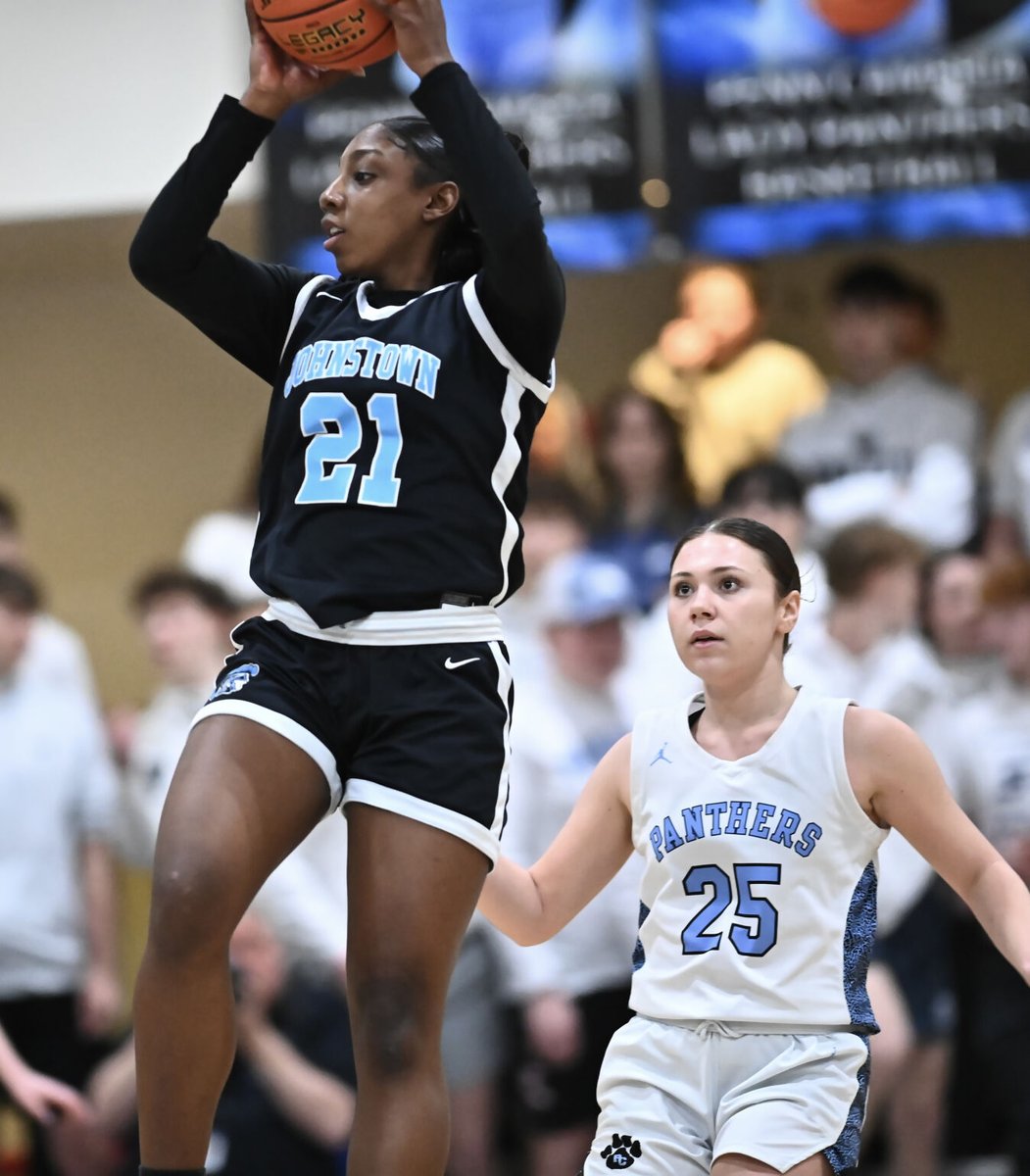 @GJSDAthletics’ NaLonai Tisinger (left) receives a high pass while guarded by @PennCambria’s Kyra Vinglish during a PIAA District VI class 4A semifinal in Cresson, Wednesday night. The Trojans won 65-55.