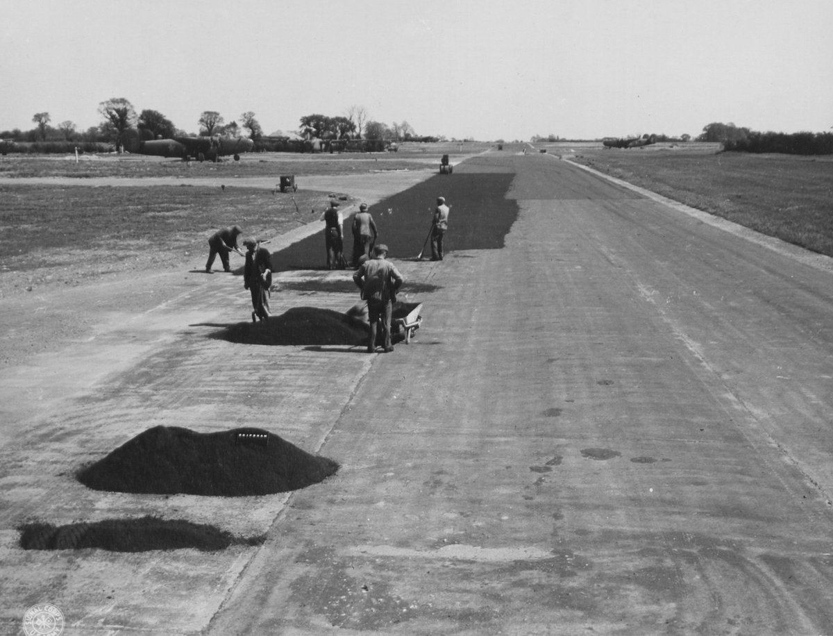 Civilian contractors in their familiar flat caps resurface the perimeter track at Shipdham airfield – AAF Station 115 – in Norfolk in June 1943.

The B-24s in the background, along with the rest of the 44th Bomb Group, would be deployed to Libya by the end of that month.